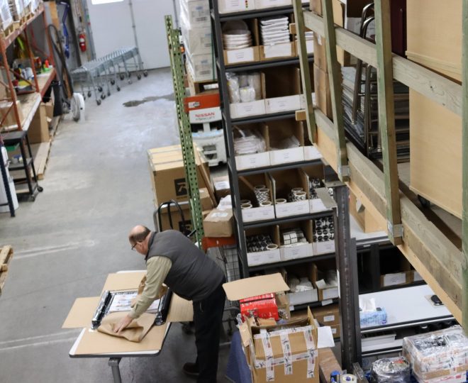 man packing items in warehouse